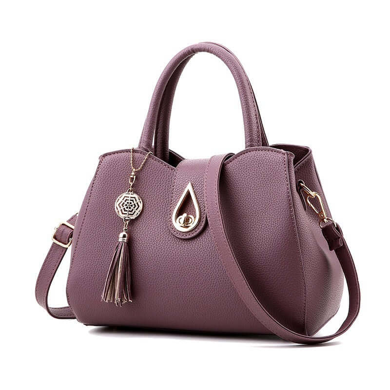 Fashion women's handbag in purple PU leather with tassel and zipper closure, perfect for stylish outings.