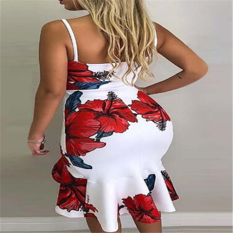 Back view of a woman in a halter irregular skirt dress featuring a white base with vibrant red floral patterns.