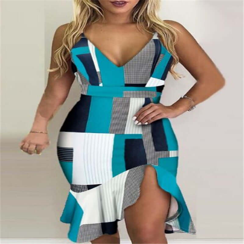 Woman in a collage-pattern halter dress with a MIDI length and irregular hem, showcasing vibrant teal and geometric designs.