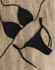 Black halter neck tie bikini swimwear for women, perfect for summer beach outings.
