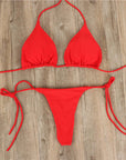 Red halter neck tie bikini for women, perfect summer swimwear. Stylish and comfortable design, ideal for beach outings.
