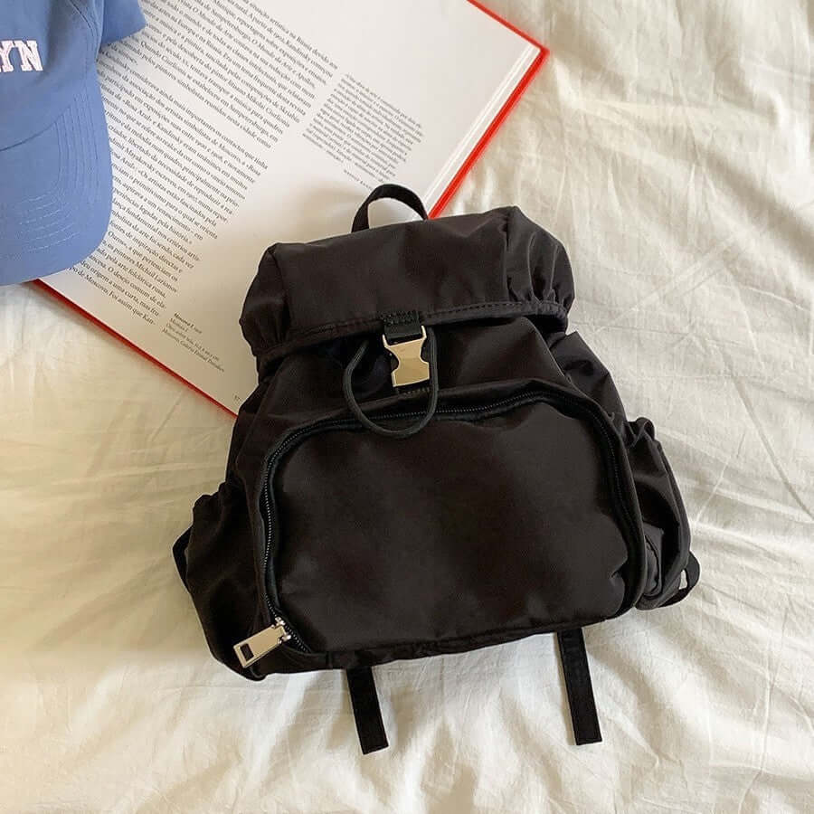 Simple small black nylon backpack for women, casual schoolbag featuring a stylish design and practical storage.