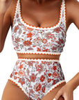 Women's swimwear featuring a floral paisley pattern bikini top and high-waisted bottom in vibrant orange and white.