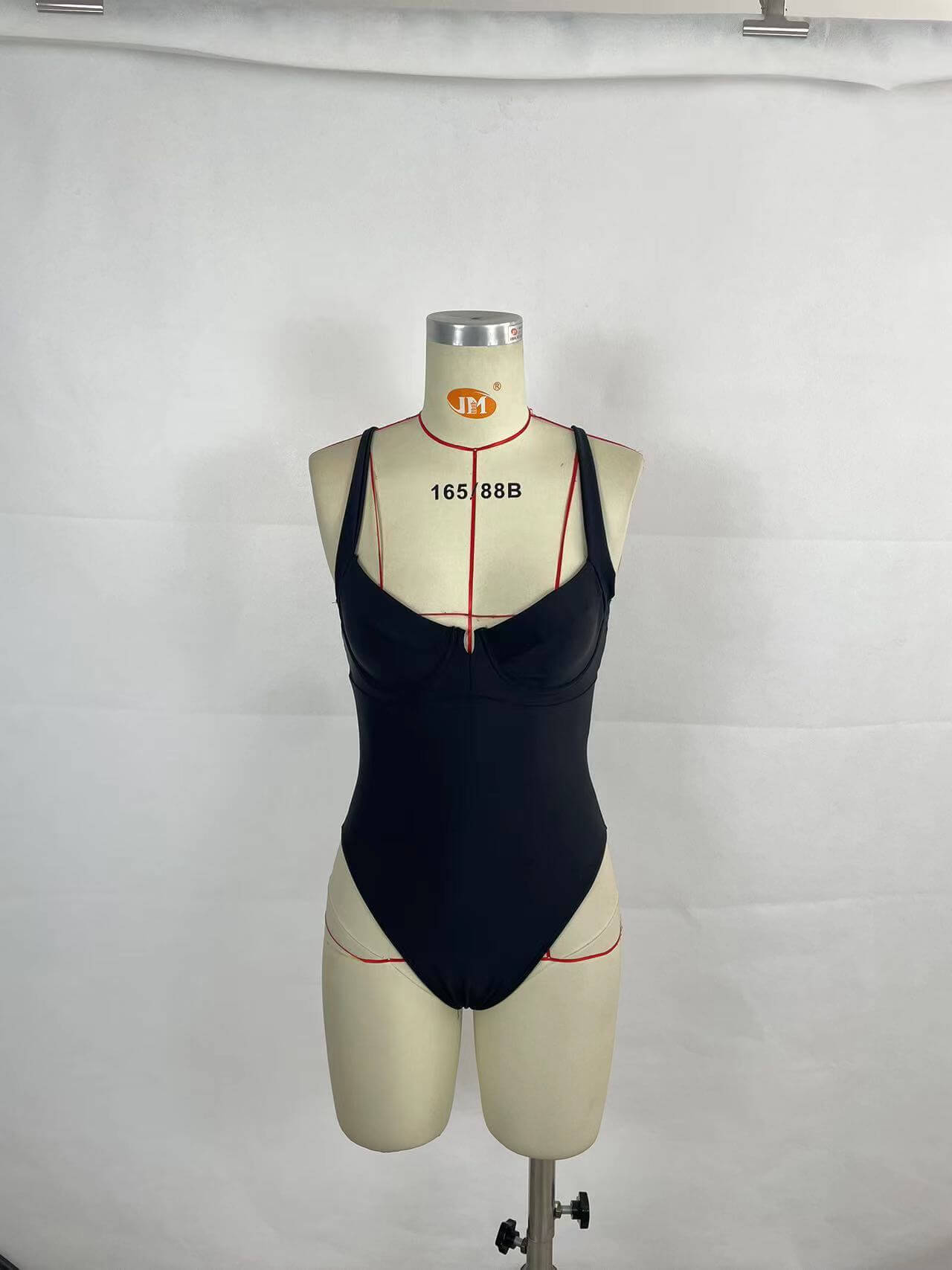 Black women's contrast color one-piece swimsuit on mannequin, showcasing chic summer swimwear style.