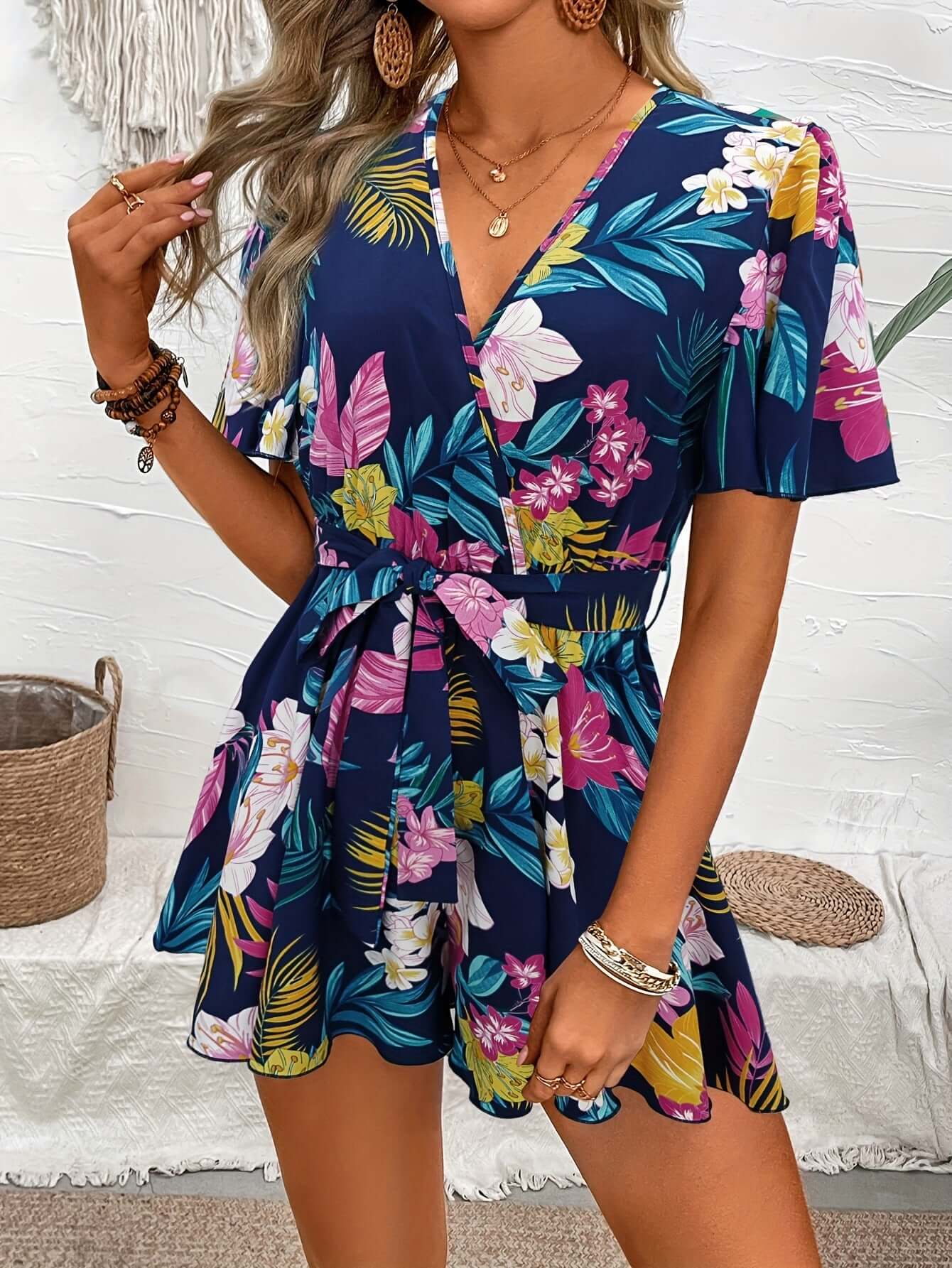 Women's floral printed jumpsuit with ruffle sleeves, perfect for summer beach vacation outfits.