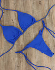 Halter neck tie bikini in vibrant blue, perfect women's swimwear for summer beach outings.