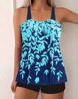 Plus size women's swimwear featuring a navy blue tankini with a split leaf print in aqua shades.