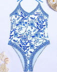 European American floral print halter backless swimsuit for women's summer swimwear, featuring elegant blue and white design.