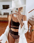 Black leopard print swimsuit set for women featuring high-waisted briefs and a stylish sleeveless top.