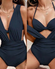 Women's nylon tied top one-piece swimsuit in navy blue, featuring a stylish cutout design and high elasticity.