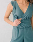 Model showcases Built-in Bra Hot Spring Boxer Print One-piece Swimsuit in teal, featuring stylish ruffles and a flattering fit.