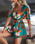 Women's printed jumpsuit with ruffle sleeves in teal floral design, perfect for summer beach vacations.