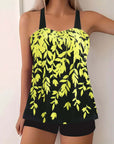 Plus size women's swimwear featuring a vibrant yellow split leaf print on a black background, perfect for summer.