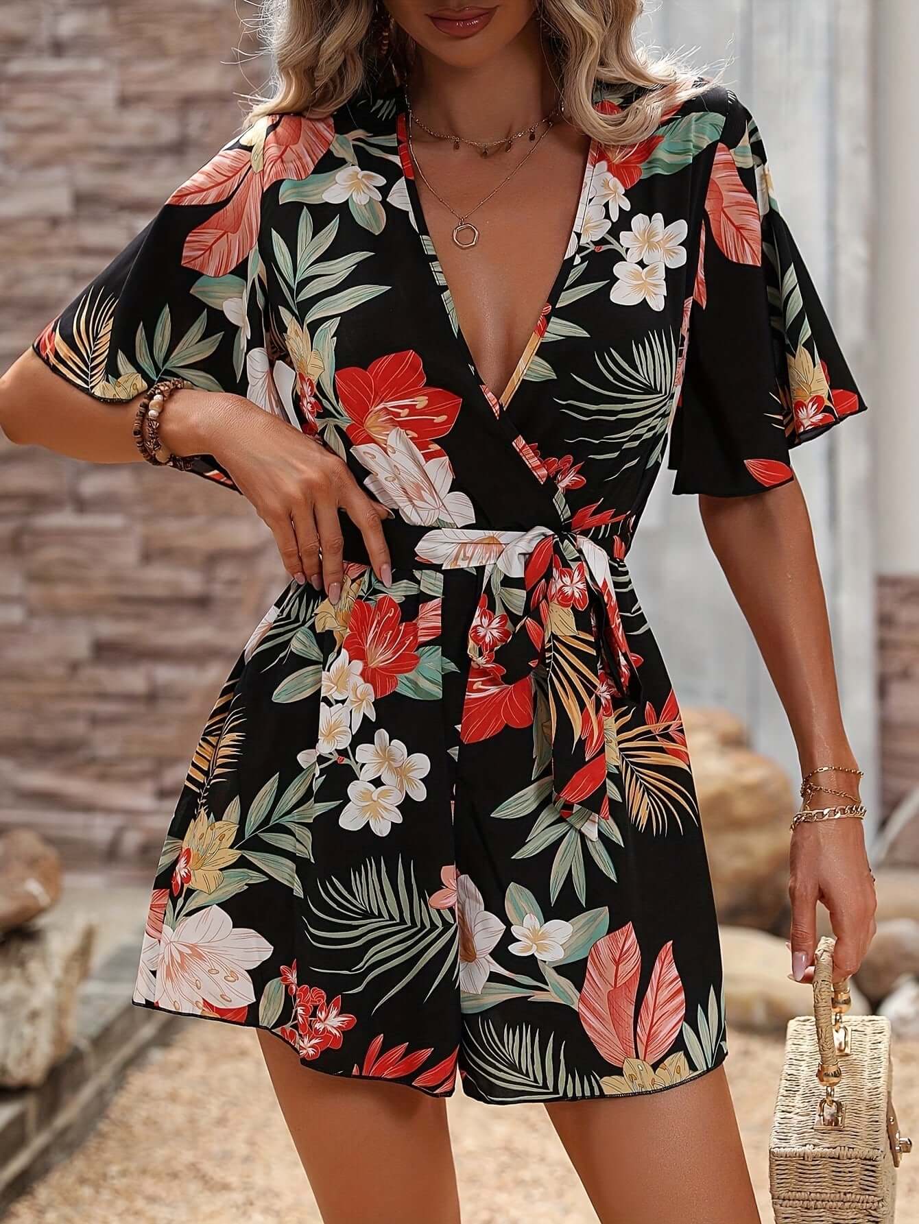 Women's summer jumpsuit with ruffle sleeves, floral print, ideal for beach vacation and stylish outfits.