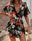 Women's summer jumpsuit with ruffle sleeves, floral print, ideal for beach vacation and stylish outfits.