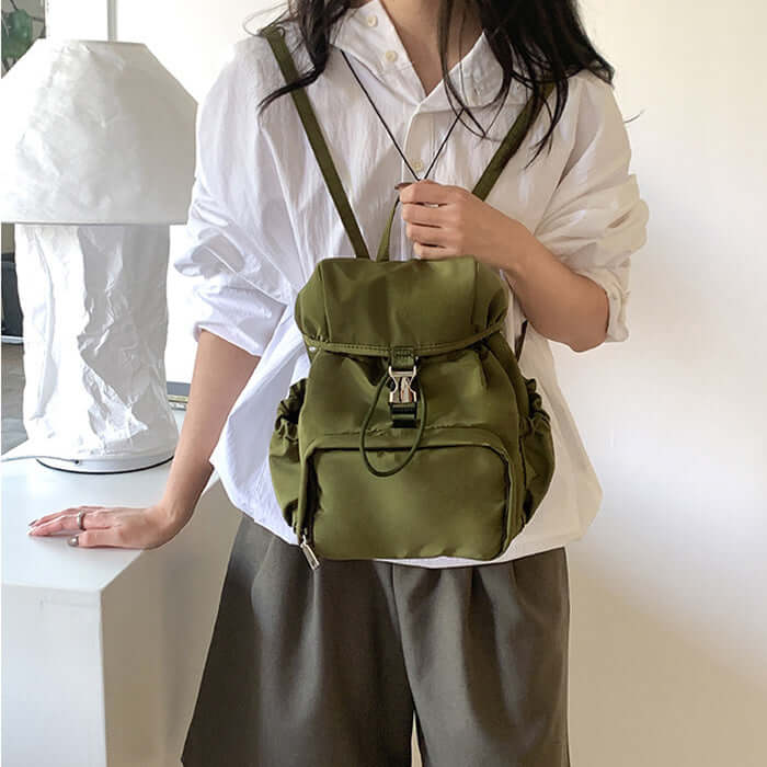 Fashionable small nylon backpack in olive green, perfect for casual outings and school, designed for women.