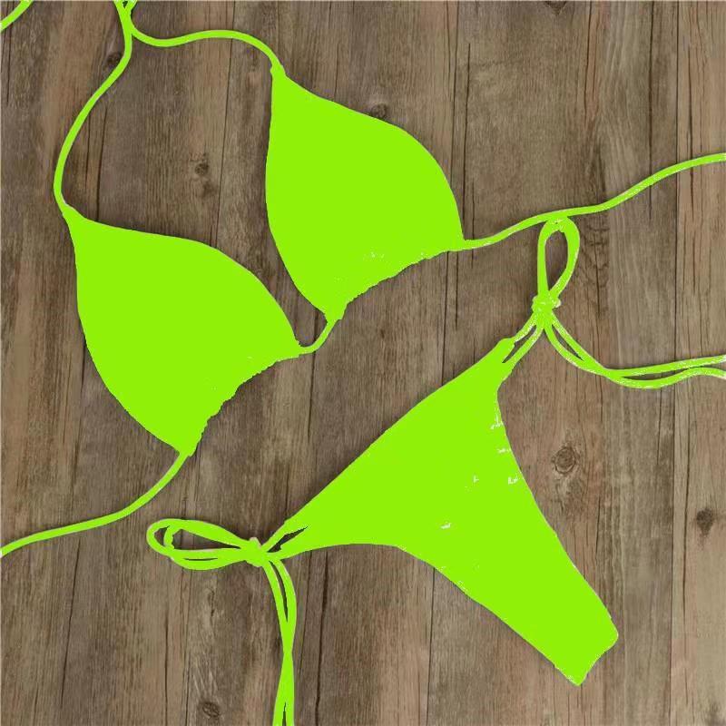 Vibrant neon green halter neck bikini set for women's swimwear on a wooden background.