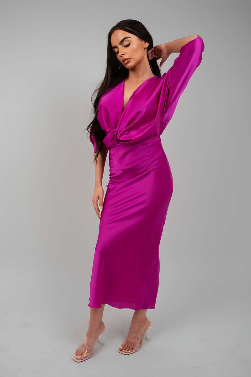 Model wearing a V-Neck Twist Front Midi Dress in vibrant pink, showcasing a relaxed fit and stylish design.