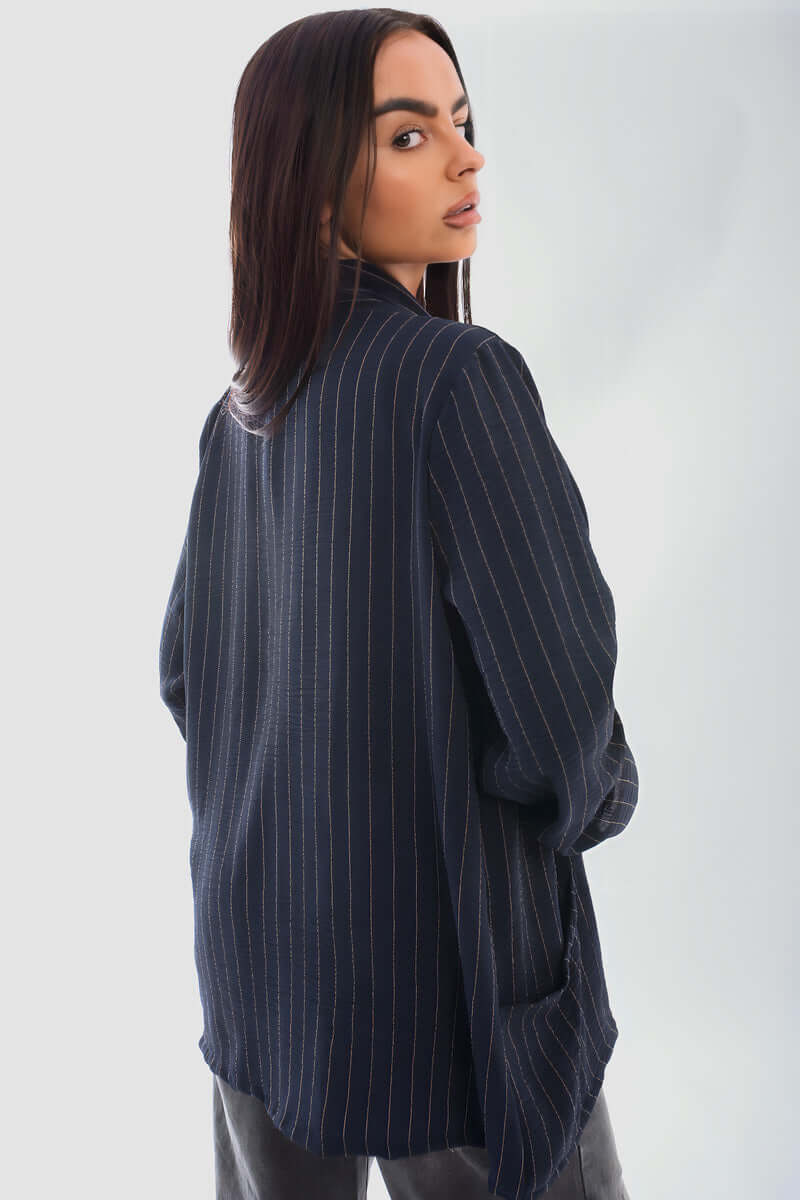 Oversized striped long sleeve cardigan with pockets, perfect for chilly days, styled with jeans.