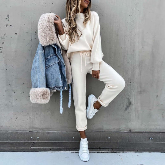 Casual two-piece suit featuring high neck long sleeve top and pocket trousers, styled with denim jacket and sneakers.