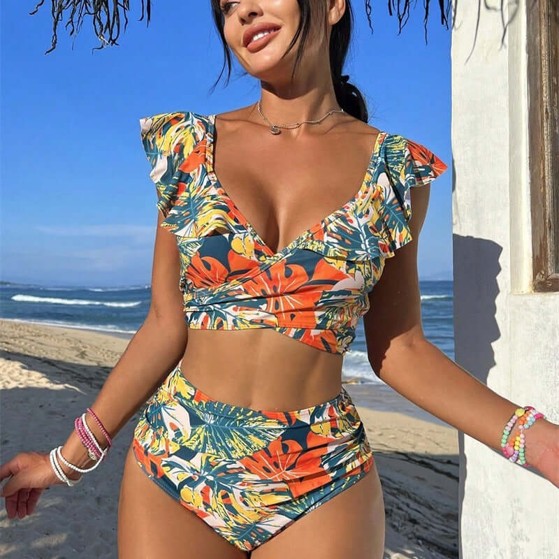 Women's two-piece ruffled halter bikini in colorful floral design, perfect for swimming, with a flattering fit near the beach.