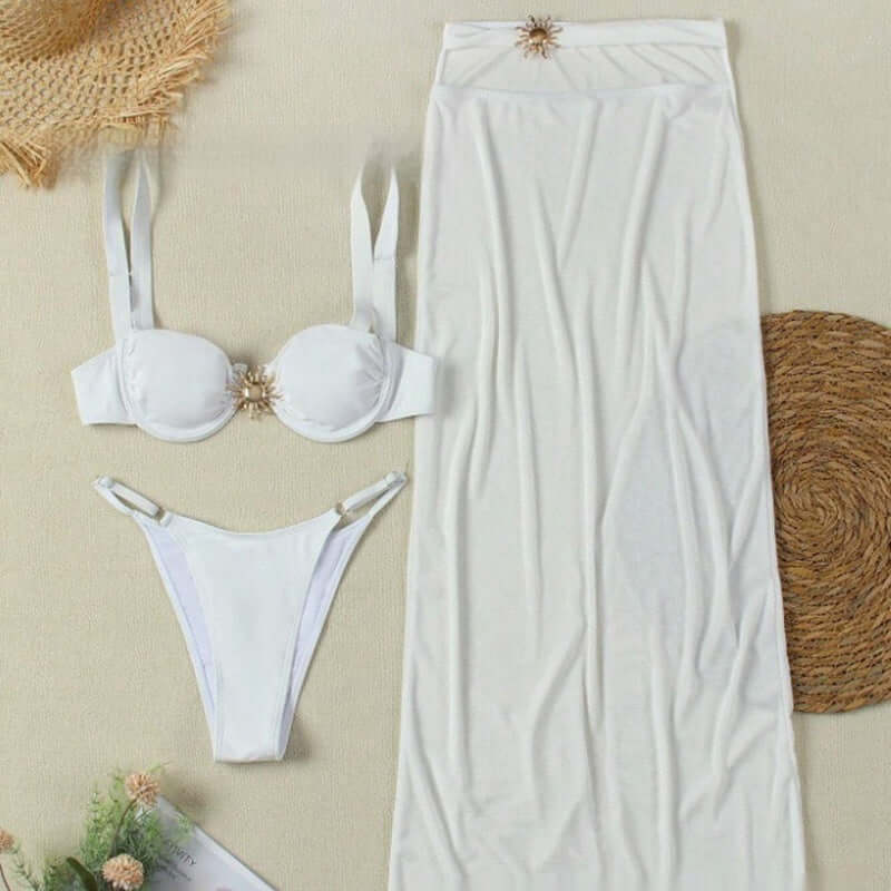 Three-piece women's swimwear set featuring a white banded bikini, trendy T pants, and a chic skirt.