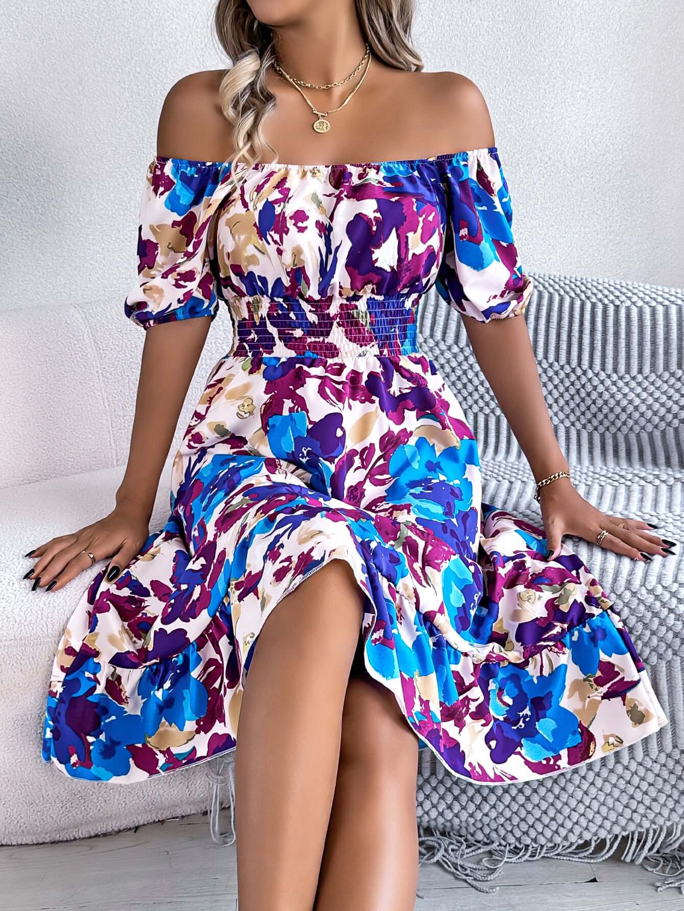 Model wearing a colorful off-the-shoulder floral dress, perfect for summer outings and casual events.