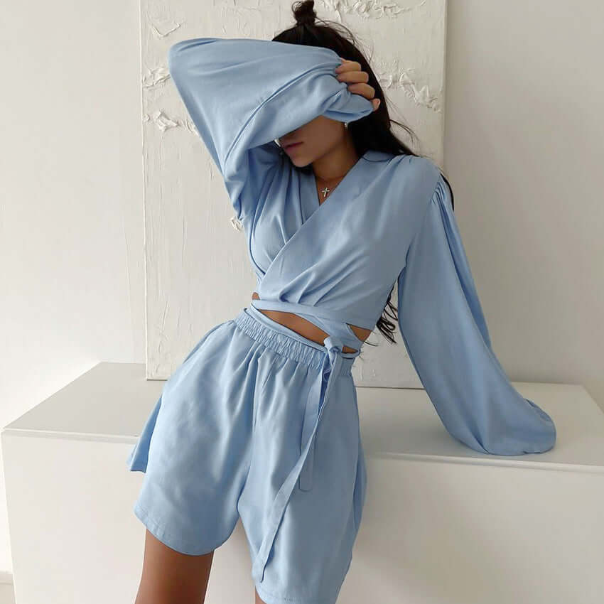 Young woman in light blue two-piece cotton pajamas, styled for casual outdoor and home wear.