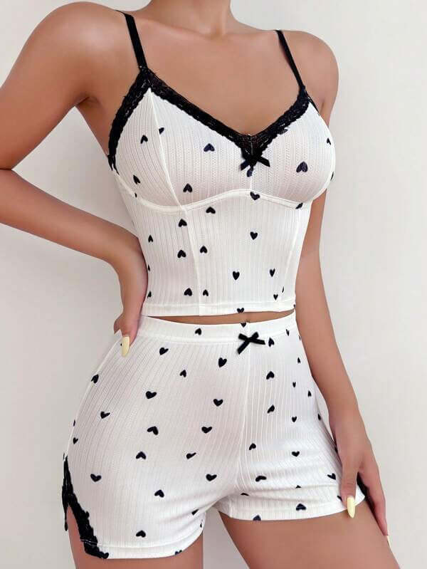 Casual women's lace spaghetti-strap shorts pajamas in white with heart patterns, perfect for comfy sleepwear.