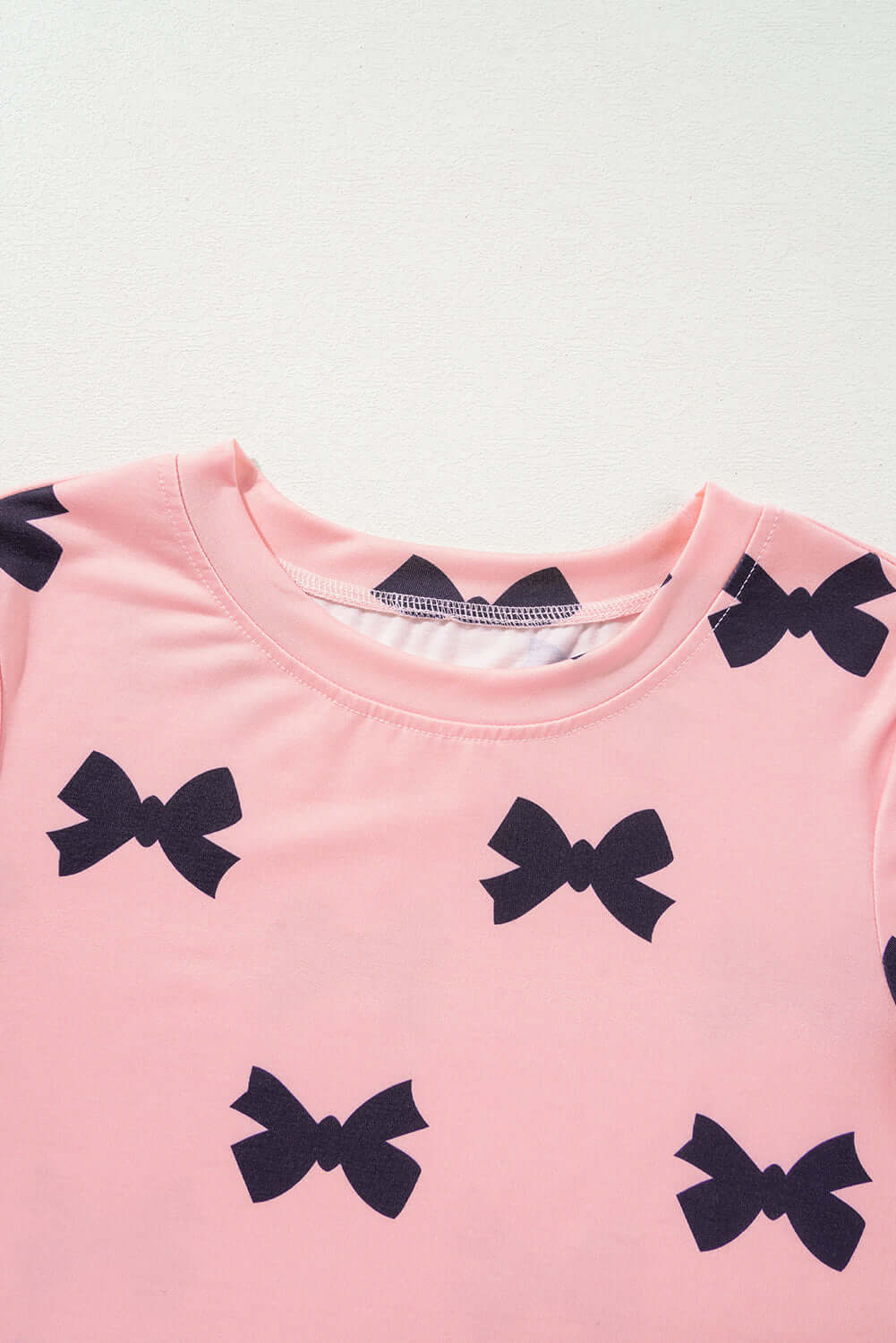 Pink short sleeve top with black bow prints, part of a women's 2pcs lounge set.