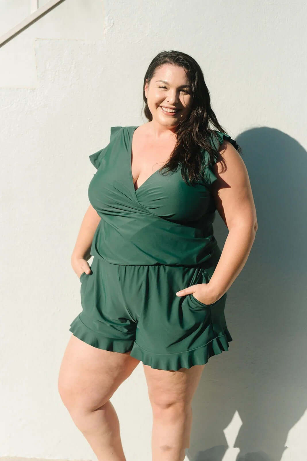 Plus-size model in green Built-in Bra Hot Spring Boxer Print one-piece swimsuit with ruffle details, perfect for summer.