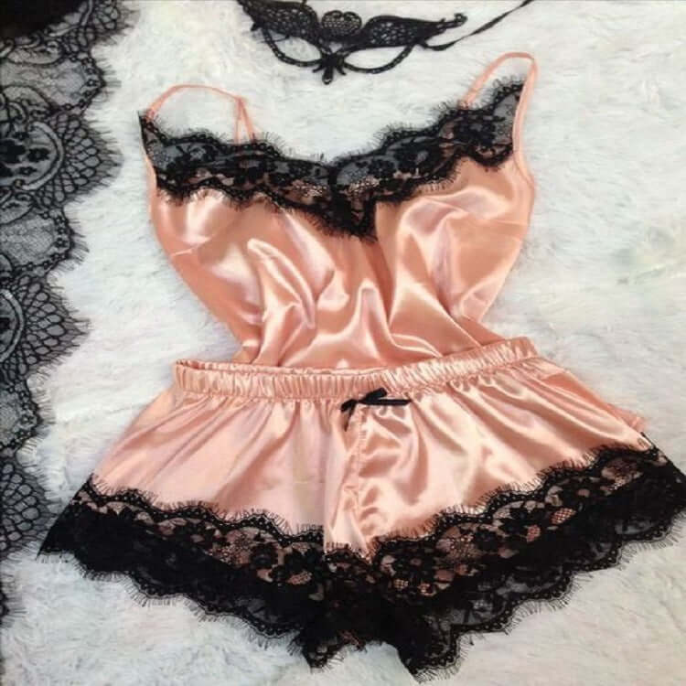 Elegant pink ice silk women's pajamas with black lace trim, perfect for stylish loungewear.