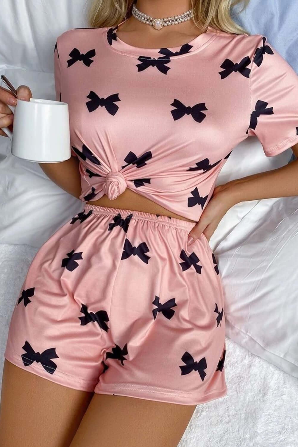 Stylish pink bow printed short lounge set for women, perfect for relaxing in PJs or casual wear.