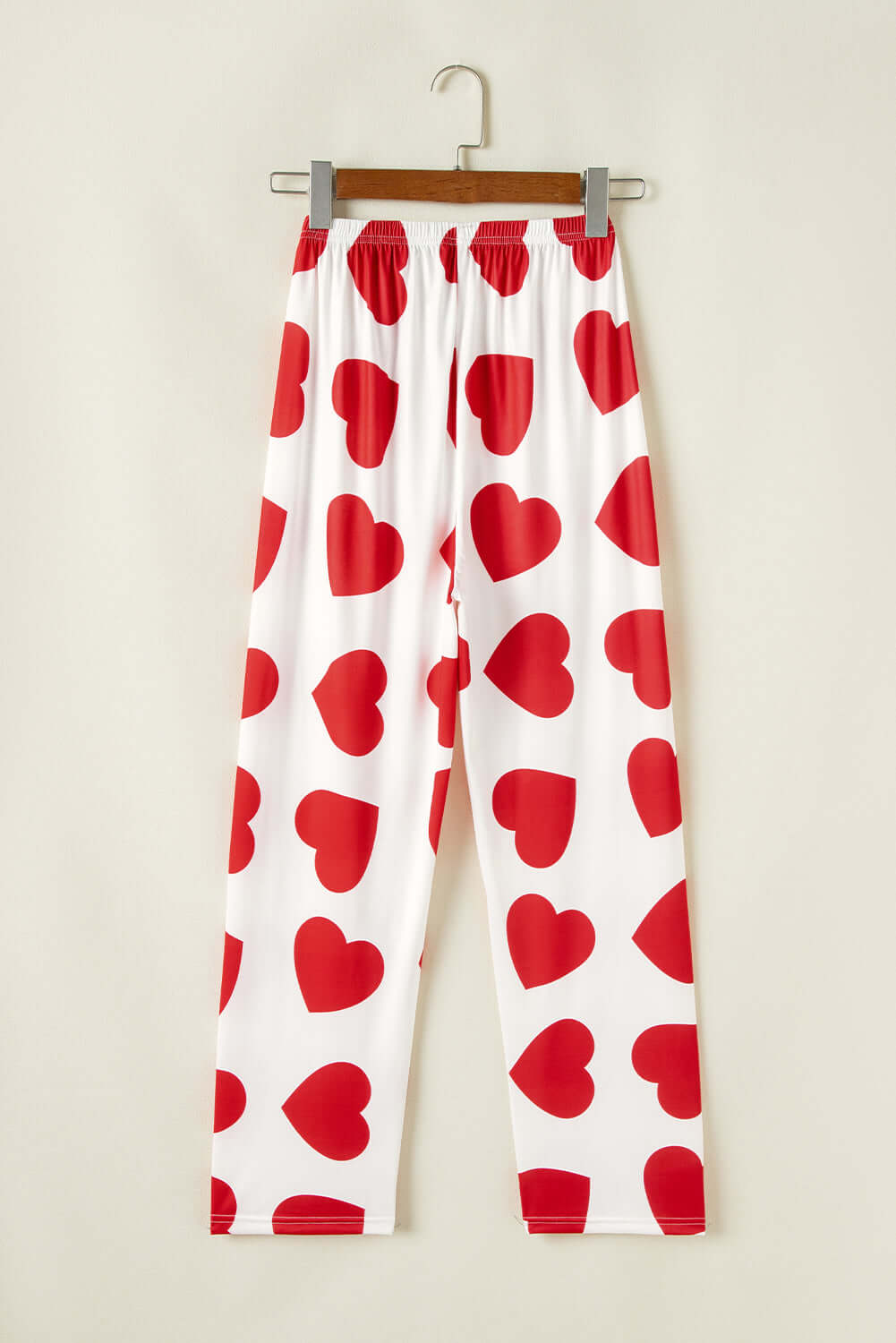 White lounge pants with red heart prints, part of a women's pajama set for a stylish and cozy look.