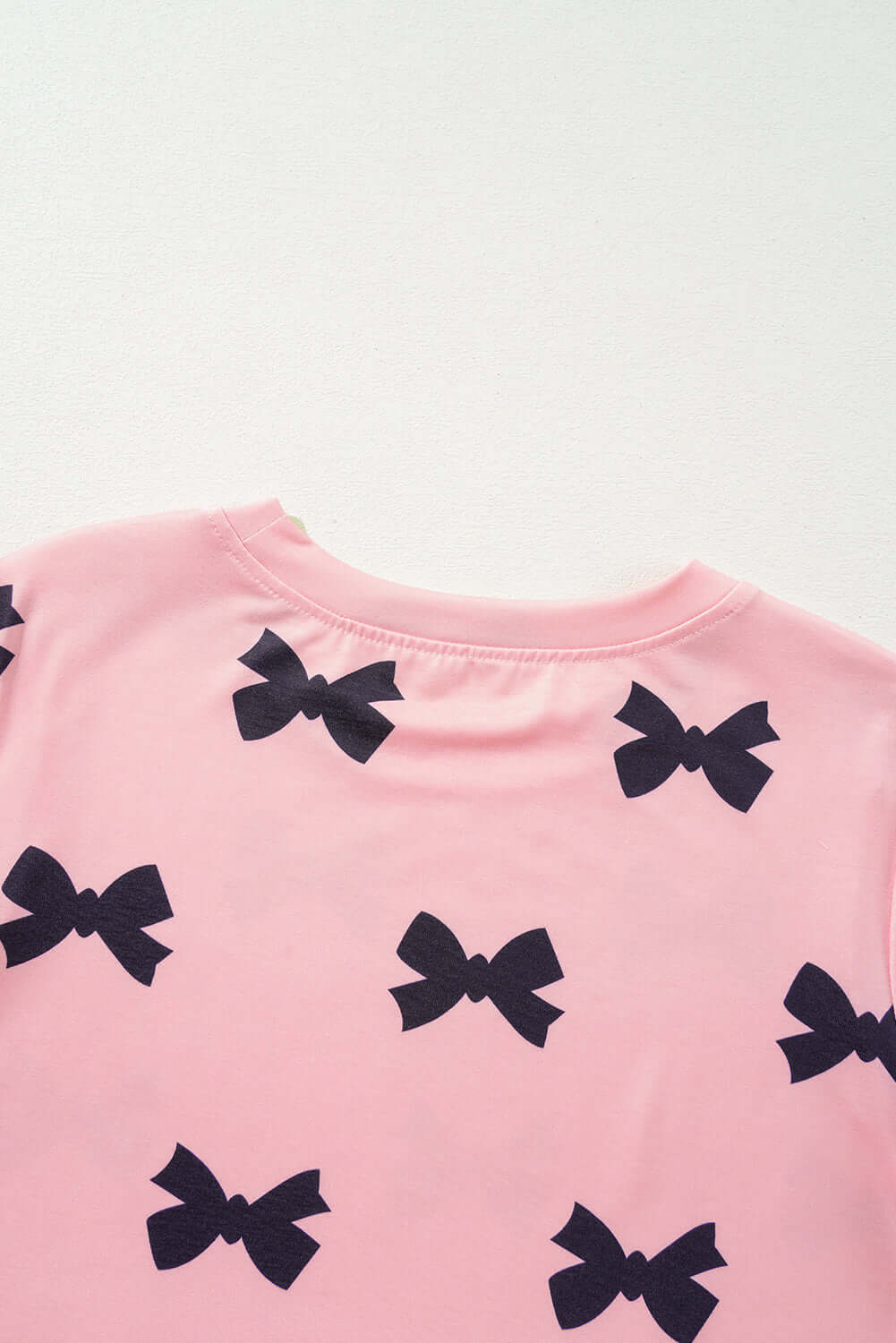 Back view of pink lounge top with black bow print from women's pjs collection by Little Miss Vanilla Clothing UK.