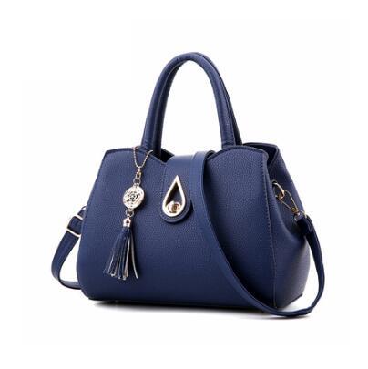 Stylish blue PU leather handbag with tassel and unique charm, perfect for women.