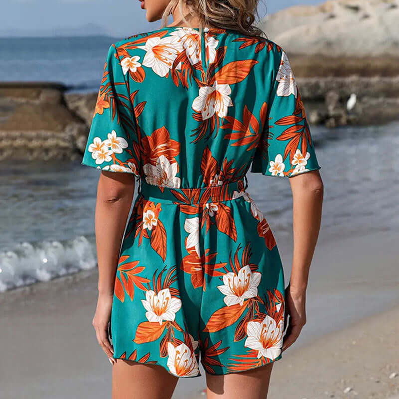 Back view of women's floral ruffle sleeve culottes jumpsuit, perfect for beach vacations in vibrant tropical colors.