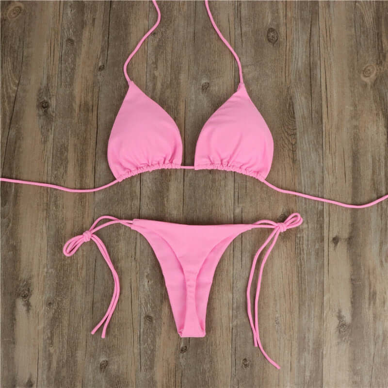 Halter neck tie bikini in pink, stylish women&#39;s swimwear perfect for summer beach outings.