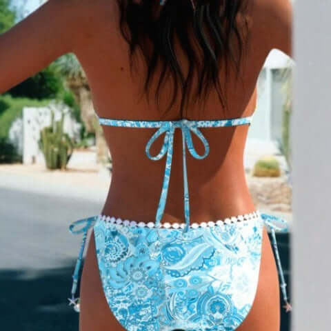 Back view of a woman's colorful bikini split swimsuit in blue and white, perfect for swimming and wading.