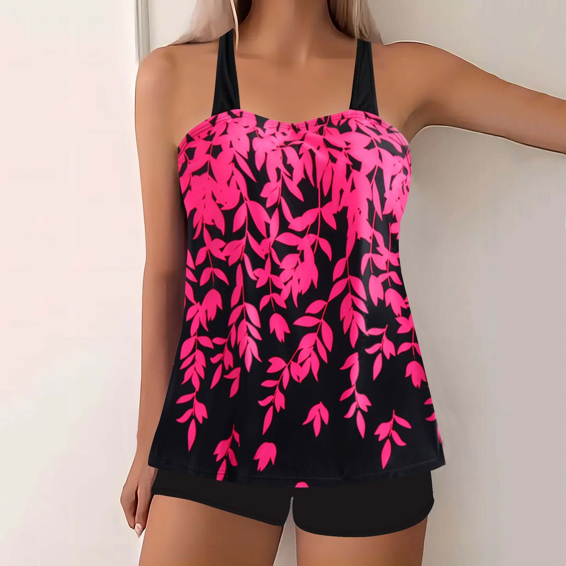 Plus size women's swimwear featuring a vibrant pink and black split leaf print bikini top and matching shorts.