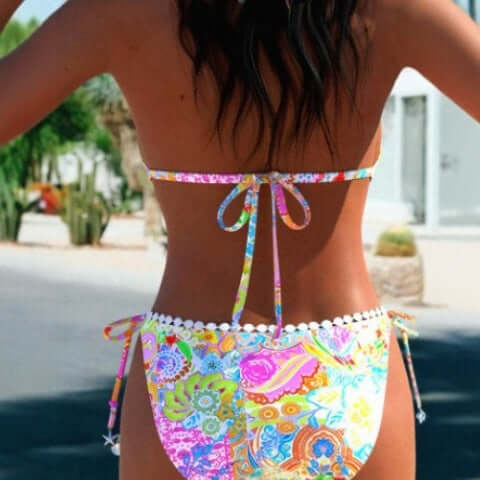Back view of colorful women's bikini split swimsuit with floral print, perfect for swimming and wading.
