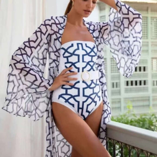 Model wearing a floral printed one-piece swimsuit with a flowy cover-up, showcasing women's swimwear style.