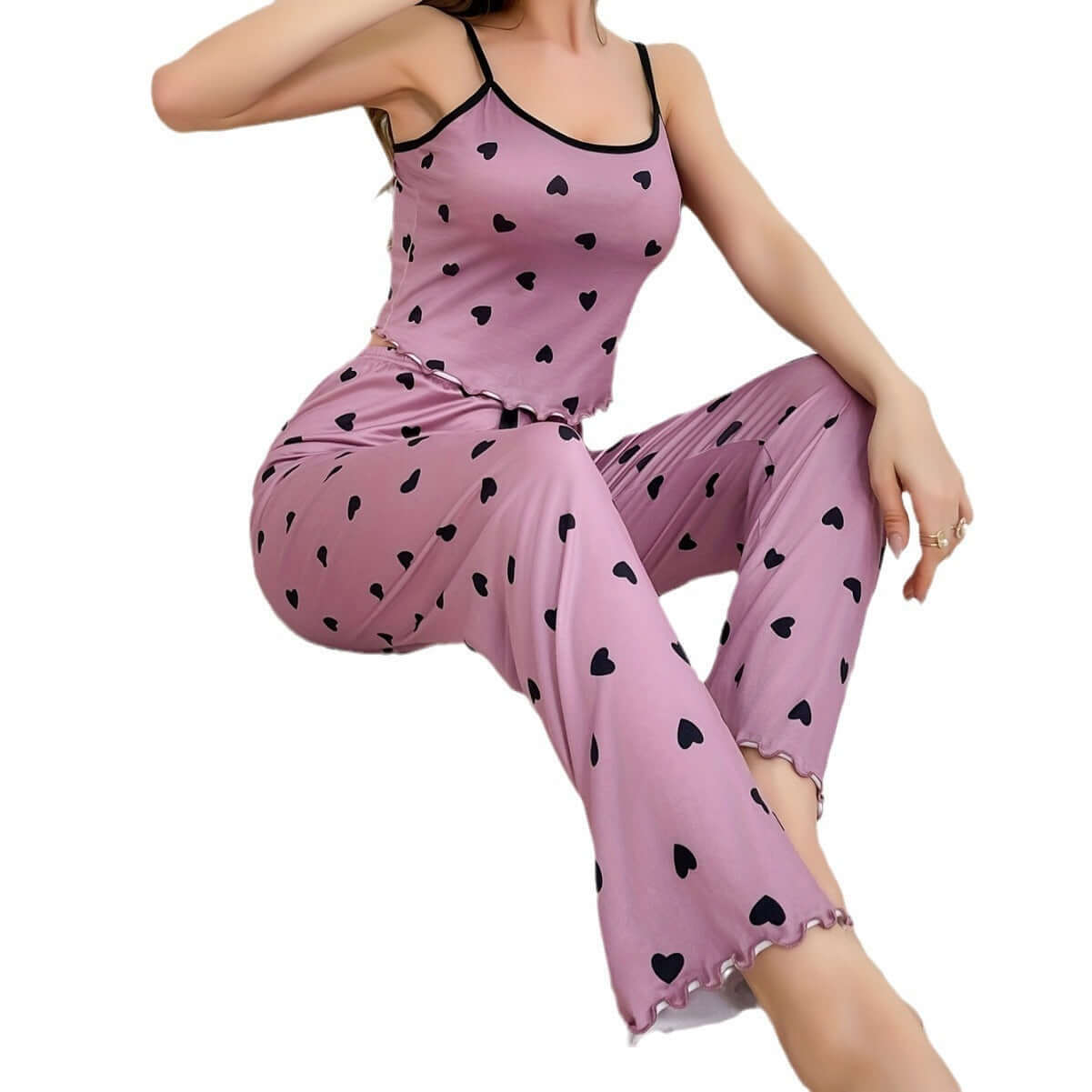 Two-piece pink milk silk pajamas with black hearts, sleeveless top and trousers, casual and breathable for comfort.