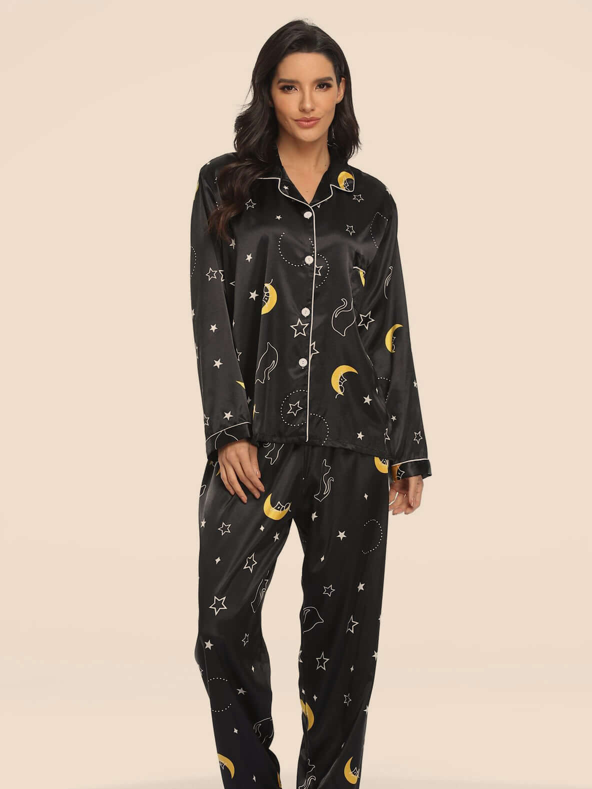 Two-piece stretch satin women's pajamas in black with moon and star patterns, perfect for cozy nights.
