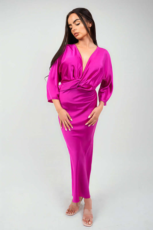 Model wearing a stylish pink V-neck twist front midi dress, showcasing a relaxed fit and trendy design.