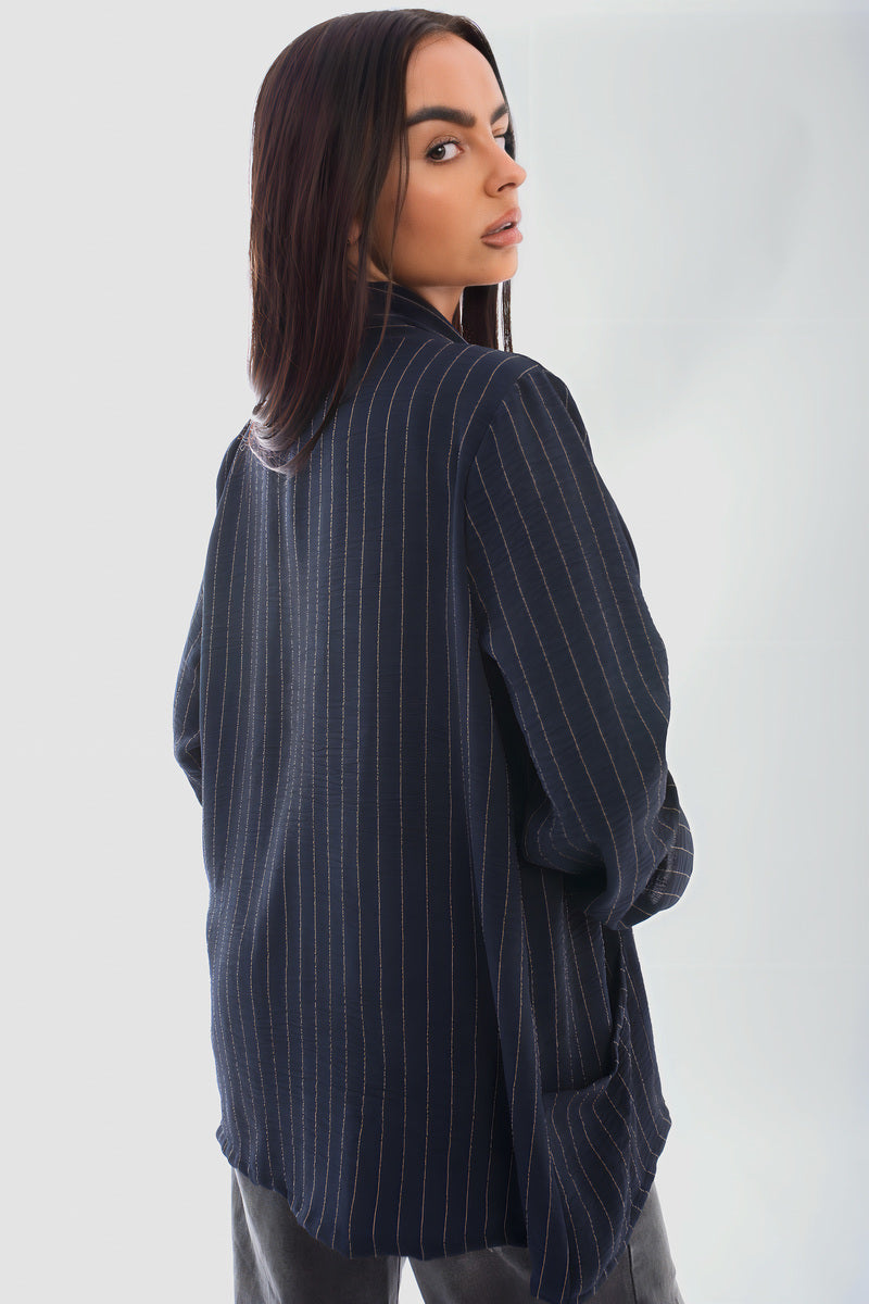 Oversized striped long sleeve cardigan with pockets, perfect for chilly days, styled with jeans.