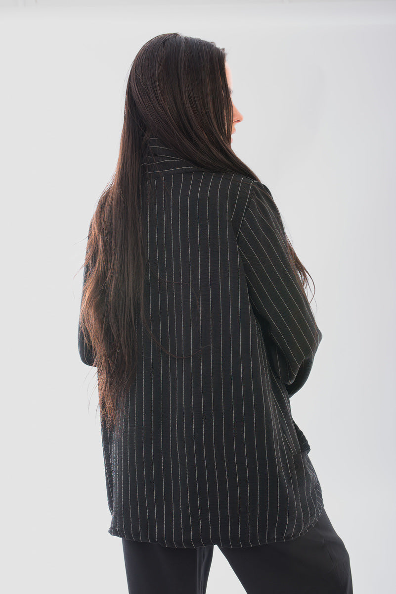 Back view of oversized striped long sleeve cardigan, showcasing its relaxed fit and stylish design.