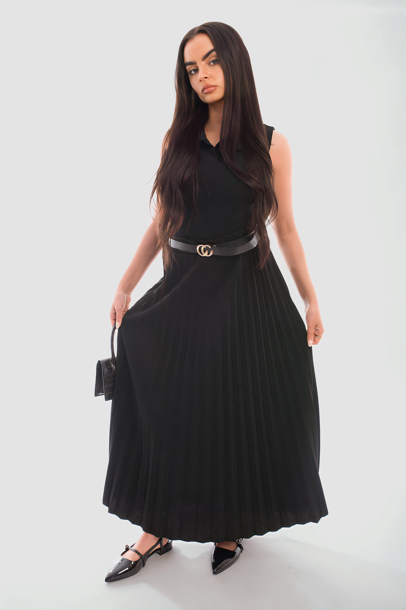 Model wearing a belted black pleated maxi skirt made from organic cotton, showcasing a relaxed fit and stylish design.